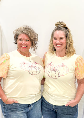 Ivory short sleeve top with sequin sleeves.  3 sequin pumpkins on the front. 