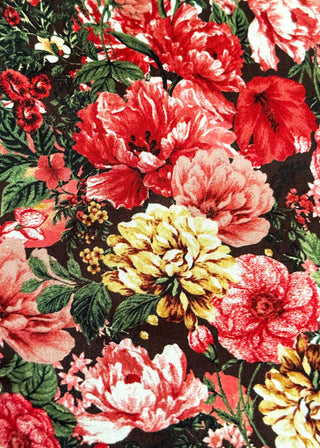 A close-up of a dense floral pattern featuring large red, pink, and yellow flowers with green leaves on a dark background.