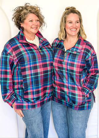 Bright plaid quarter-zip pullover in navy, teal, and pink with front pockets.