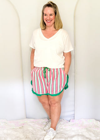 Pink and green striped ruffle hem shorts with elastic waistband, pockets, and drawstring for women