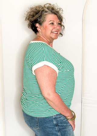 Green and white striped short sleeve top with white banding on sleeve and collar. 