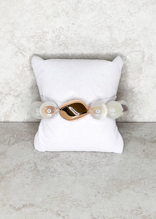 clear/white beaded stretch bracelet with single gold bead