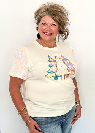 Short sleeve top with iridescent sequin sleeves and pastel sequin Christmas tree appliqués on the front.