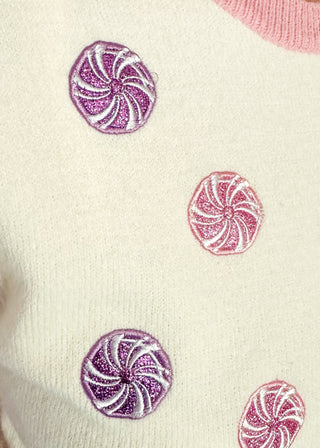 Cream short sleeve sweater with puff sleeves, pink trim, and sequin peppermint candy accents on the front