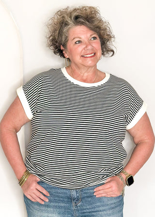 Black and white striped short sleeve top with white banding on sleeve and collar. 