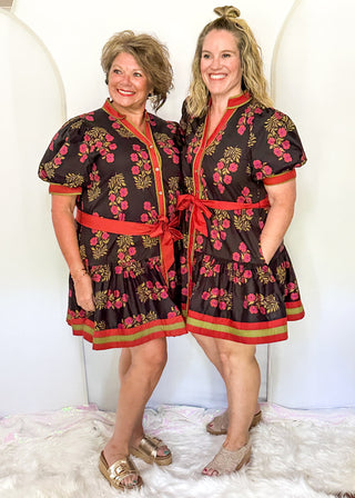 Short sleeve belted dress in black with berry florals and contrast piping.  Button up. 