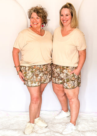 Camo print athletic shorts with dark green trim