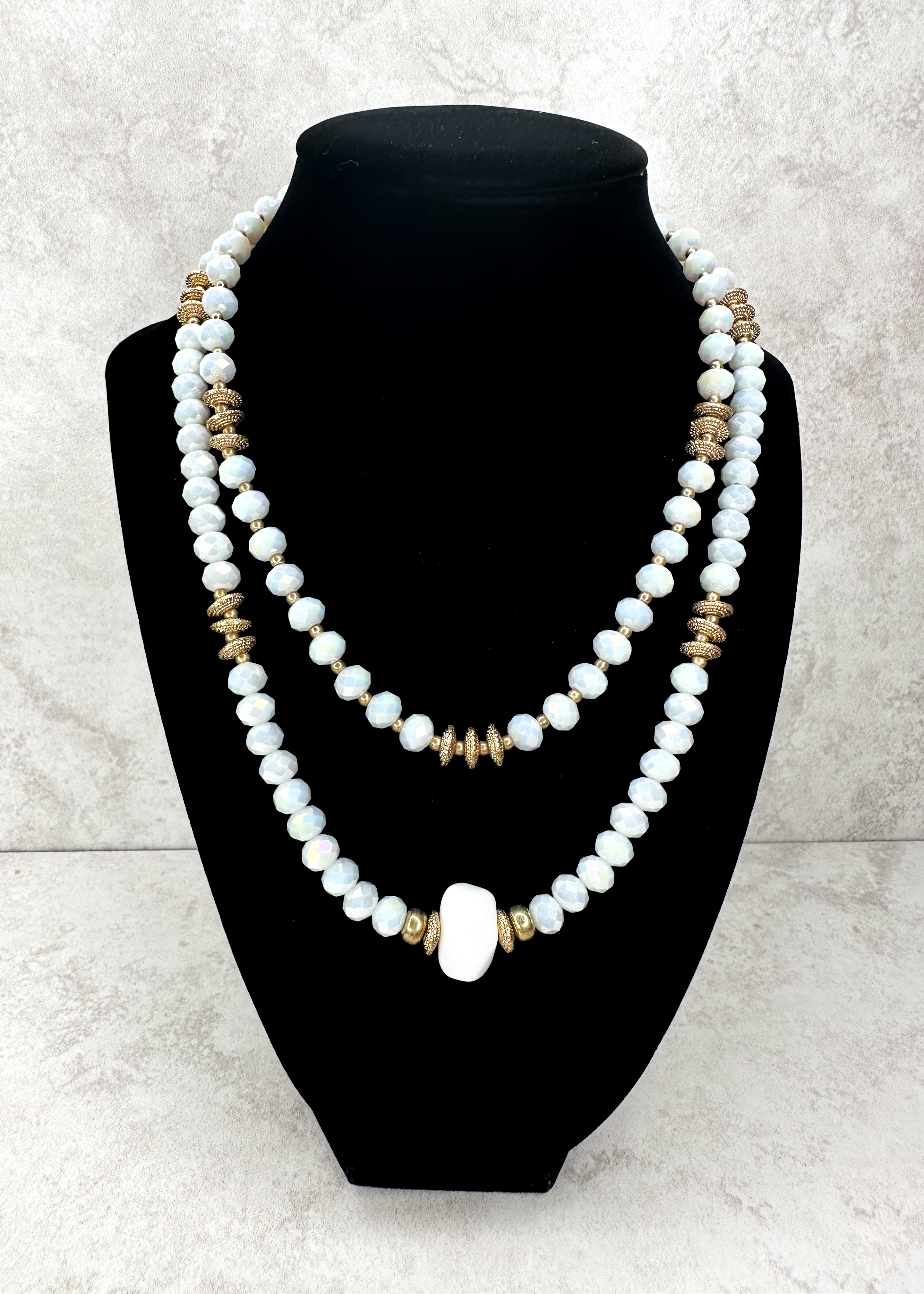 double strand iridescent white and gold beaded necklace - larger single bead at the bottom of longer necklace - gold hardware