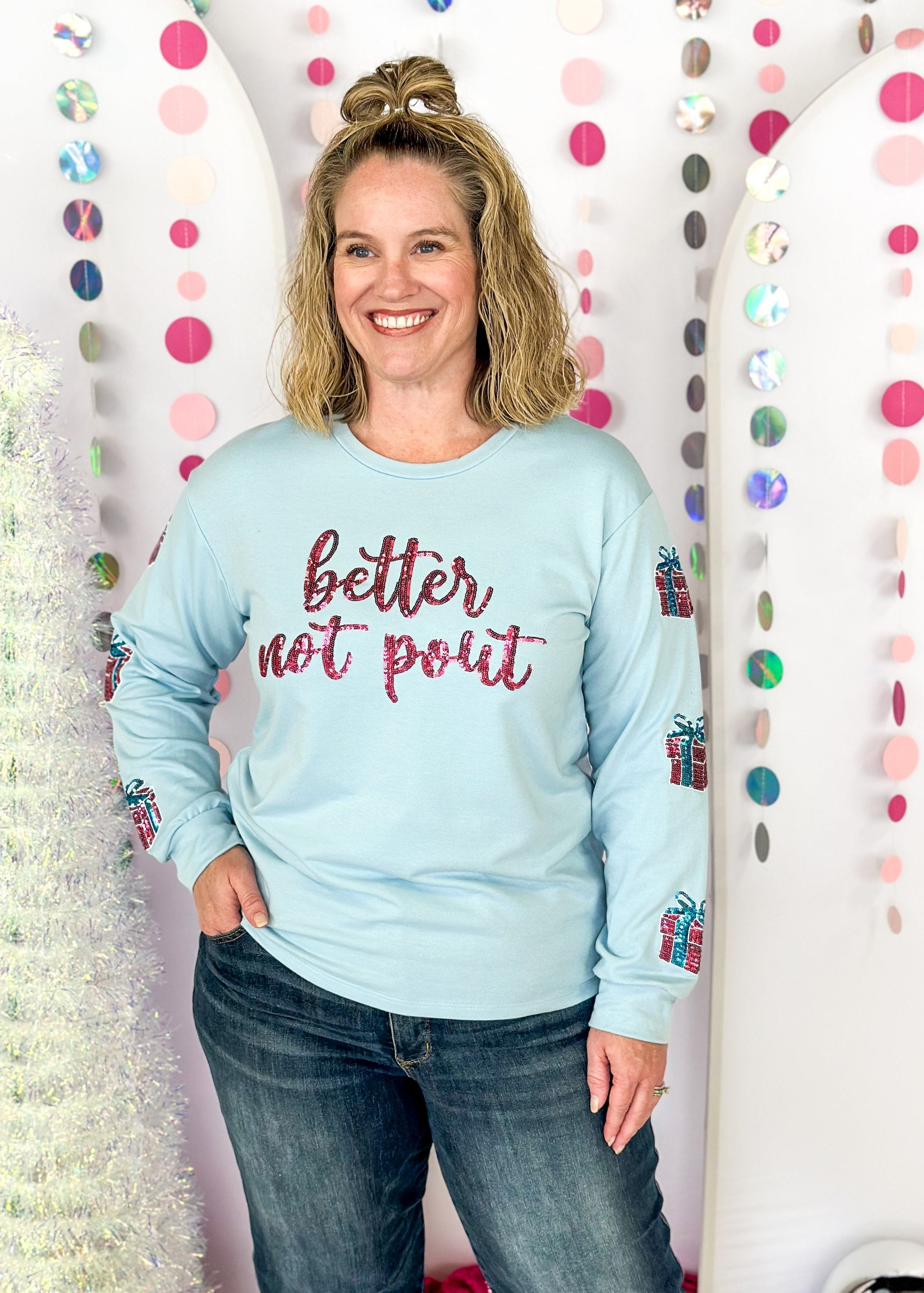 light blue long sleeve top - thicker than a tee shirt but not as thick as a sweatshirt - better not pout spelled out in pink sequins across the front - pink and blue present sequin patches down the sleeves