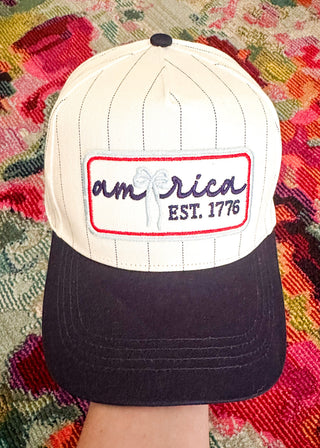 Embroidered patch baseball cap in cream and navy colors