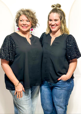 black top featuring sparkly sequin puff sleeves and a relaxed, flowy body.