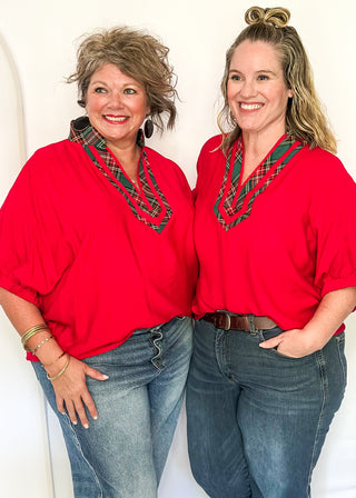 Red dolman sleeve top with plaid contrast neckline and trim detail