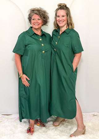 Models wearing short sleeve, collared, Hunter Green midi dress with decorative gold snaps.