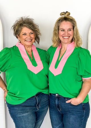 green puff short sleeve top with pink around v-neck and collar and arm banding