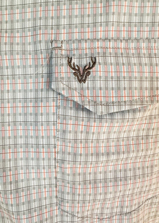 Close-up of a plaid shirt pocket with a dark embroidered deer head logo on the flap. The fabric has a gray, white, and thin red plaid pattern.