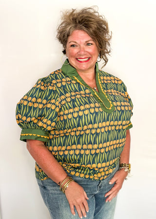 Large puff sleeve top with golden tulips and green leaves.  Contrast is green with yellow scallop detail-short sleeve and v-neck.