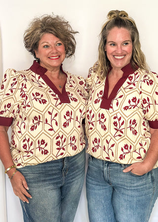 Neutral blouse featuring garnet florals with geometric hexagon pattern.