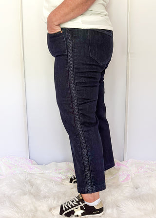 side view of women's Judy Blue dark wash jeans with braided side trim, high-rise waist, and classic five-pocket styling.