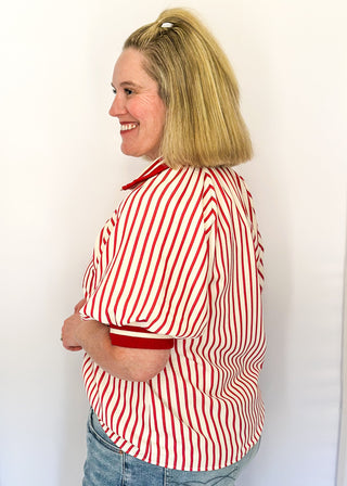 Women’s red striped short sleeve 1/4 zip top with lightweight fabric, stripe elastic sleeve and collar detail.