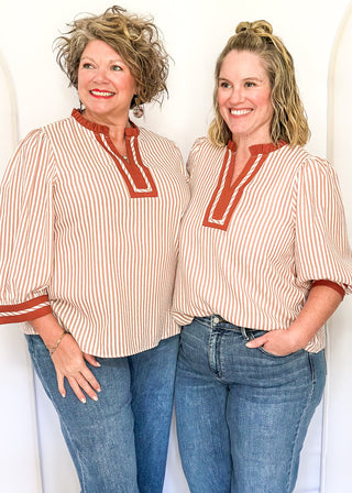 Cinnamon-brown striped blouse with a split neckline, contrast trim, and 3/4 sleeves.