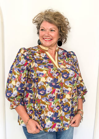 floral top with cream and brown striped detail around collar and v-neck - 3/4 sleeve - browns, blues, magenta, creams, greens, for floral colors