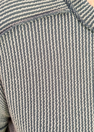 Close-up of a textured fabric with blue and white stripes