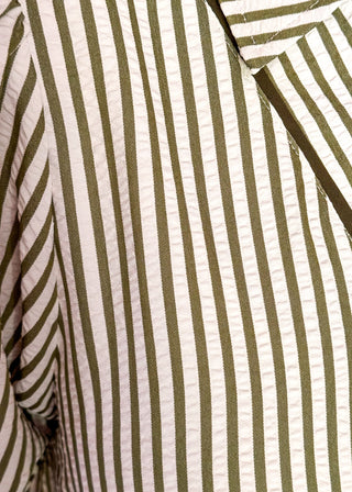 Close up of vertical Stripe Dress in a relaxed silhouette with collar, solid olive contrast detail and pockets.