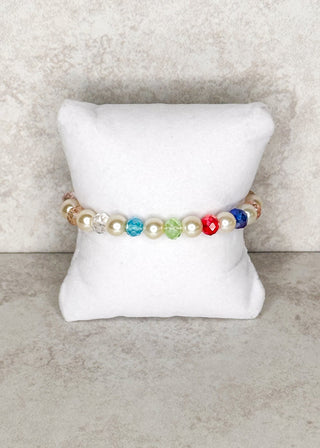 Multi colored beaded bracelet displayed on a stand 