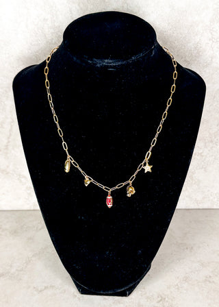 Gold necklace with football charms displayed on a black neck form
