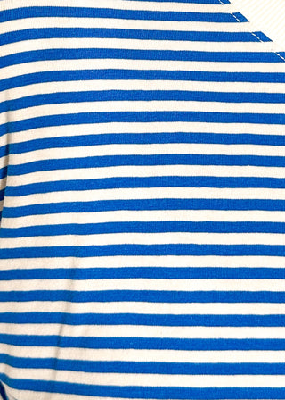 Close up of blue and white striped short sleeve top with white banding on sleeve and collar. 