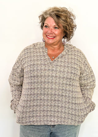 tweed hooded long sleeve top with pockets.  Colors of purple, cream, gray