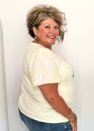 Short sleeve top with iridescent sequin sleeves and pastel sequin Christmas tree appliqués on the front.