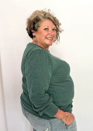 long sleeve ribbed top with cuff sleeve and small puff detail in shoulder. crew neck. 