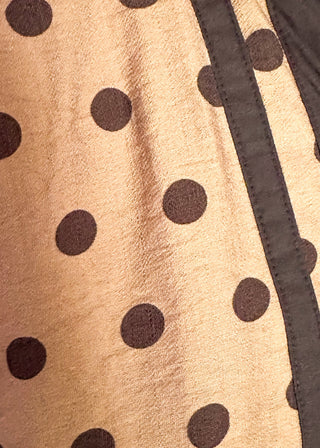 close up of camel dolman top with chocolate polka dots.