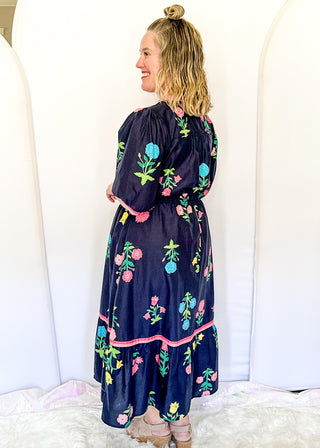 Colorful floral navy midi dress featuring pink contrast trim and a gathered waistline