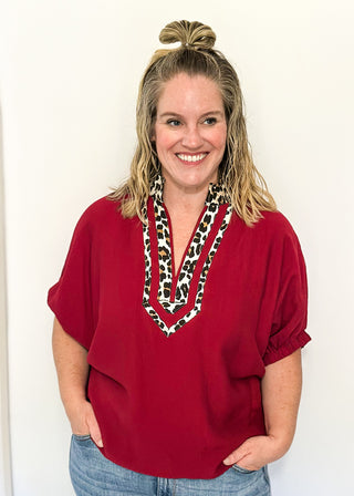 dolman short sleeve top in garnet color with double leopard stripe v-neck