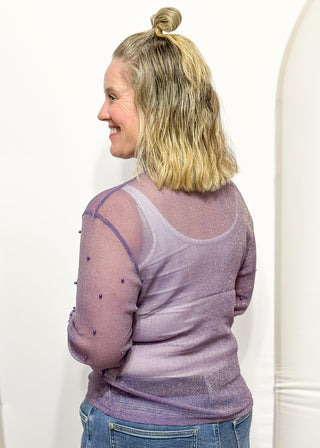 Long sleeve mock neck top with pearl accented sleeves in purple with gold metallic threads.