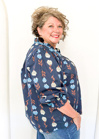 navy 3/4 length top with light blue and cream flowers and brown stems - light blue scalloped trim detail around v-neck