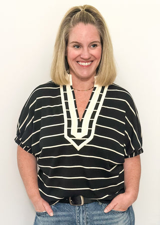 Black and cream striped dolman top with cream trim and flowy short sleeves.