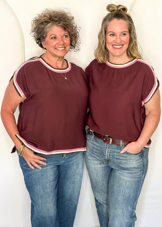 two models standing in Merlot top with pink and white contrast detail. 