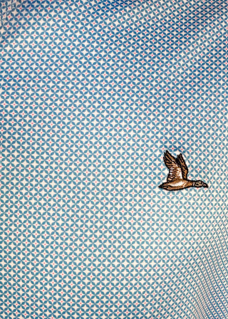 Close up of geometric patterned men's polo shirt