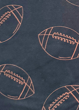 Black Skort with pockets and tie at waist. Brown football pattern throughout.