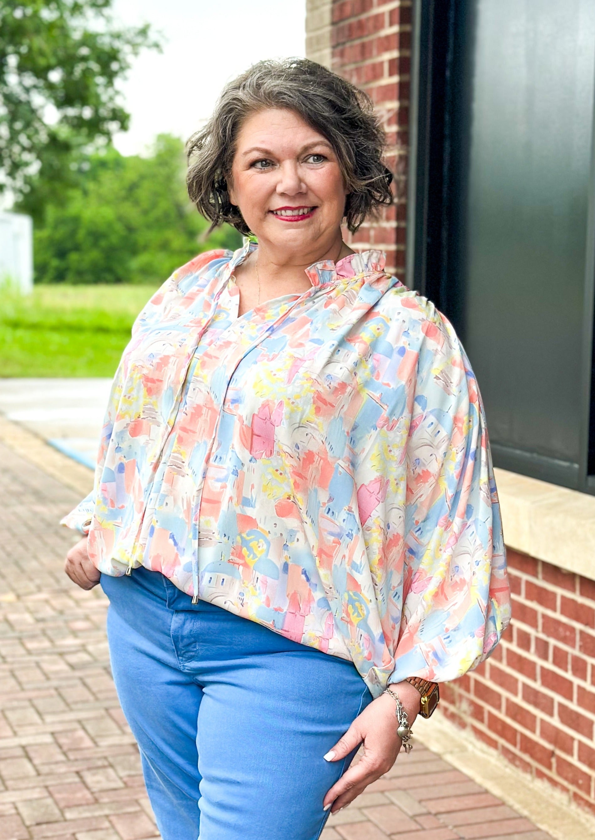 Pastel abstract print with building - v-neck with tie and ruffle - dolman 3/4 sleeve with elastic - lightweight