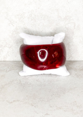 Wine bangle bracelet displayed on a stand 