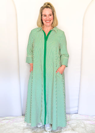 Green vertical striped collared dress with button-down front with green contrast, 3/4 sleeves, midi length, and side pockets.