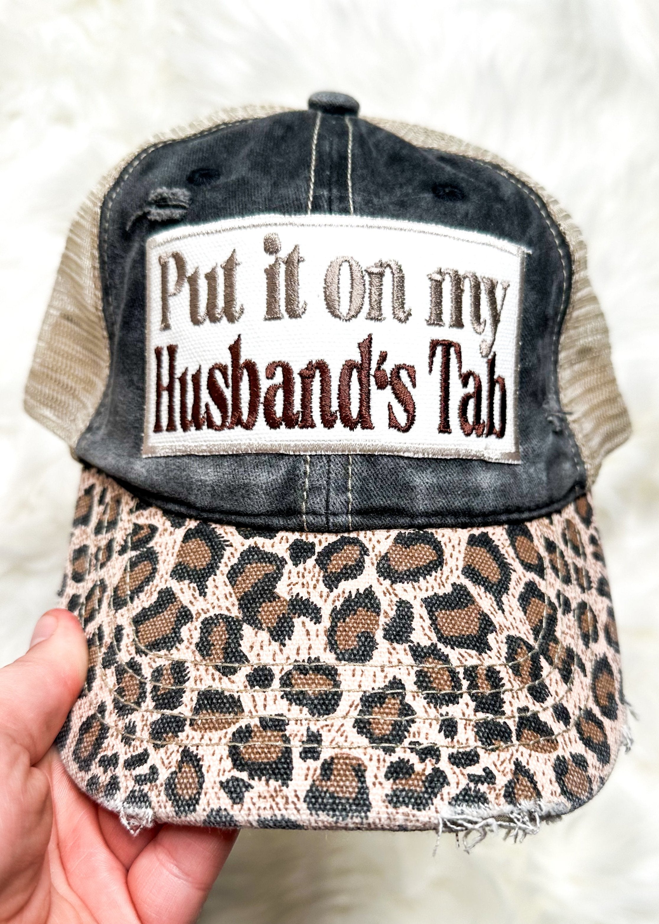 leopard bill snap back trucker hat - front is a charcoal gray and back is a khaki net - neutral put it on my husband's tab embroidered patch on the front