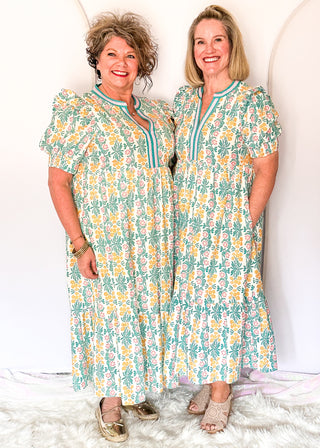 Floral midi dress with contrast neckline, short puff sleeves, and tiered skirt