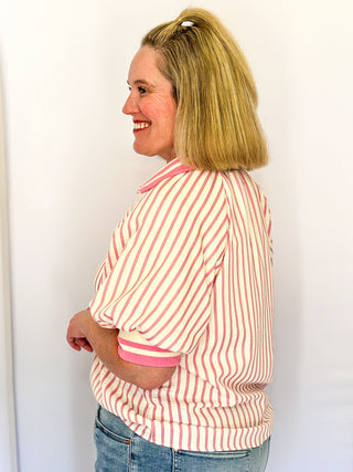 Women’s pink striped short sleeve 1/4 zip top with lightweight fabric, stripe elastic sleeve and collar detail.