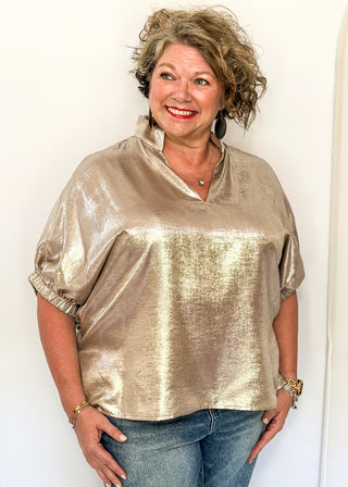 Shimmer Champagne V-neck blouse with relaxed elastic short sleeves and a split hem at waist. 