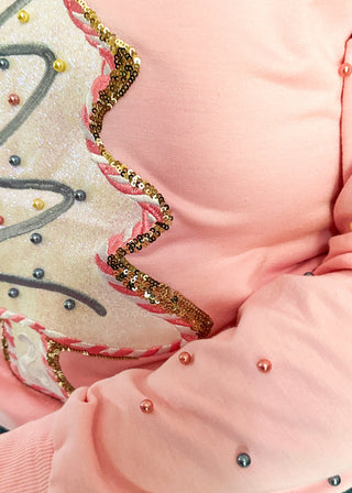 Light pink long sleeve top with sequin Christmas tree appliqué and beaded sleeve accents